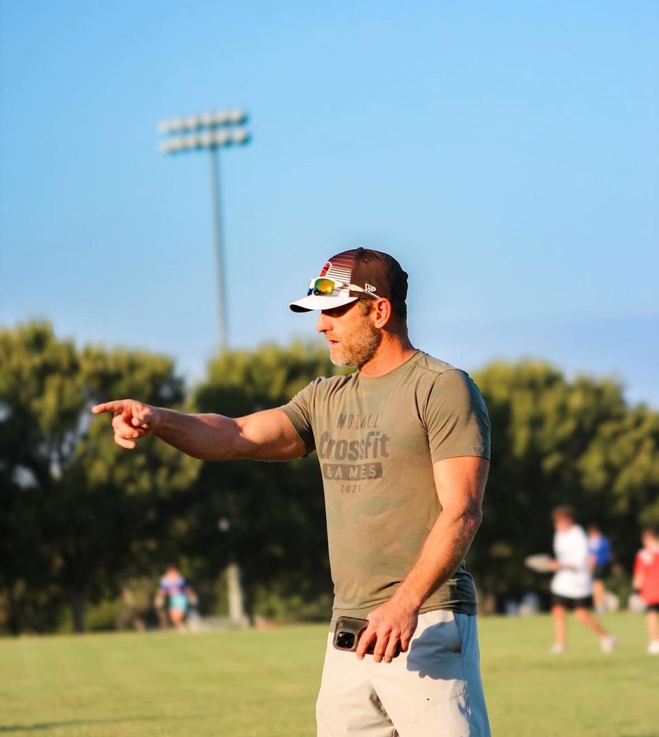 Kerry coaching on the field, pointing out the next play